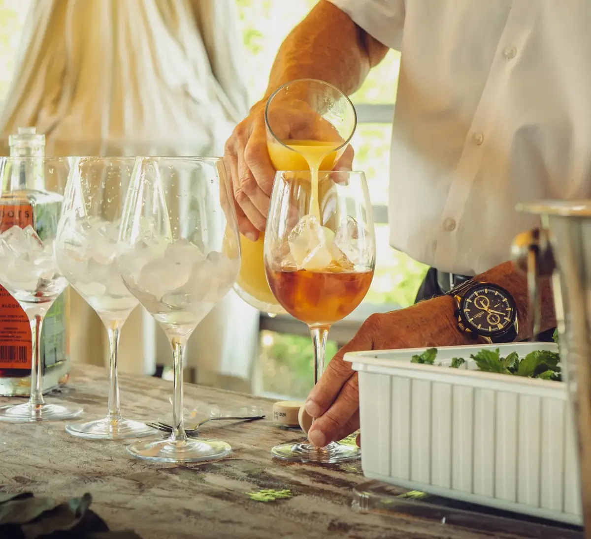 Bartender pouring a craft cocktail at a private party